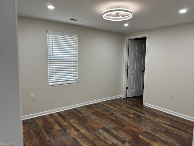 spare room featuring dark hardwood / wood-style floors