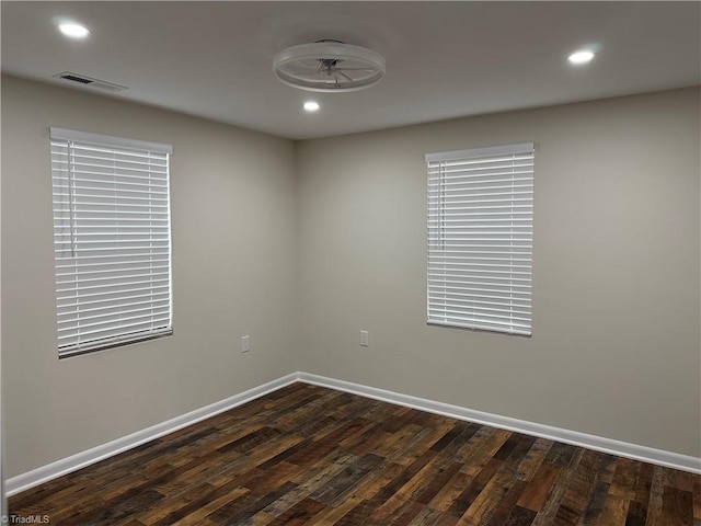 unfurnished room with dark wood-type flooring