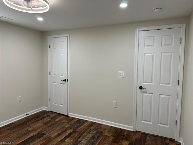 unfurnished bedroom with visible vents, recessed lighting, baseboards, and dark wood-style flooring