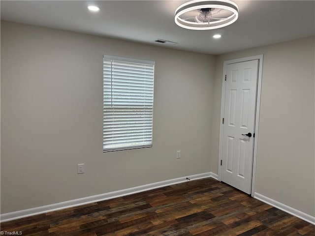 unfurnished room featuring recessed lighting, visible vents, baseboards, and dark wood-style flooring