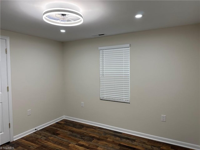 unfurnished room with dark wood-type flooring