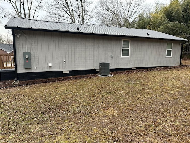 view of home's exterior featuring central AC and metal roof