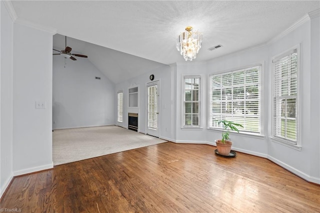 unfurnished living room with baseboards, visible vents, wood finished floors, and a fireplace