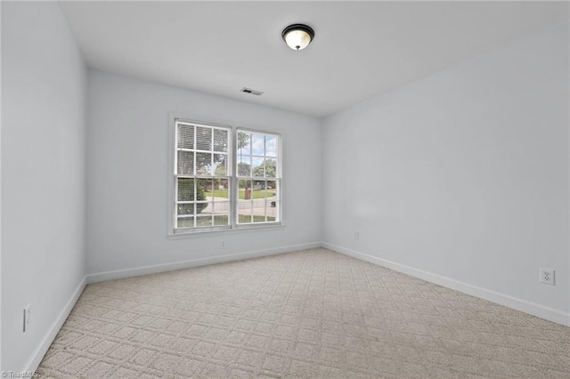 carpeted empty room with visible vents and baseboards