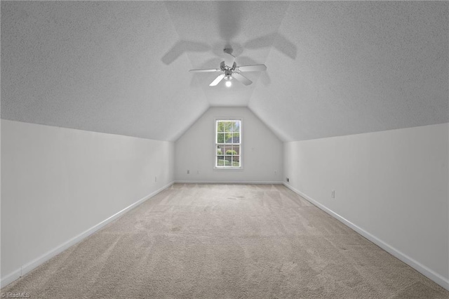 bonus room with carpet floors, a ceiling fan, a textured ceiling, and baseboards