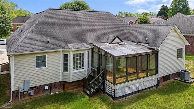 rear view of house featuring a lawn, crawl space, central AC unit, and a sunroom