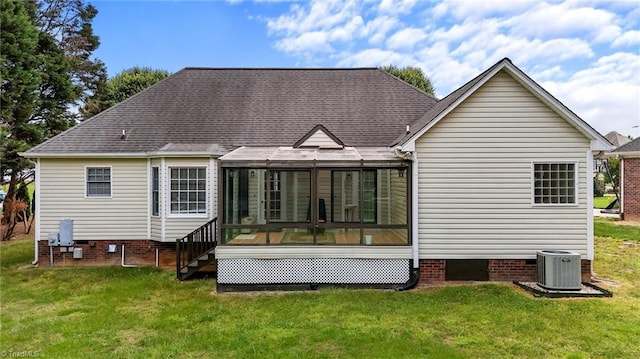 rear view of house with a yard, crawl space, central AC, and a sunroom