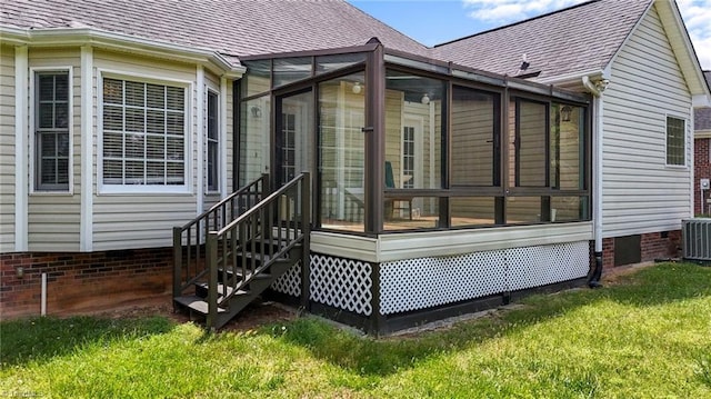 back of house with a sunroom, a shingled roof, a lawn, and crawl space