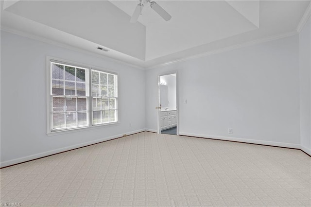 empty room with crown molding, carpet floors, ceiling fan, and baseboards