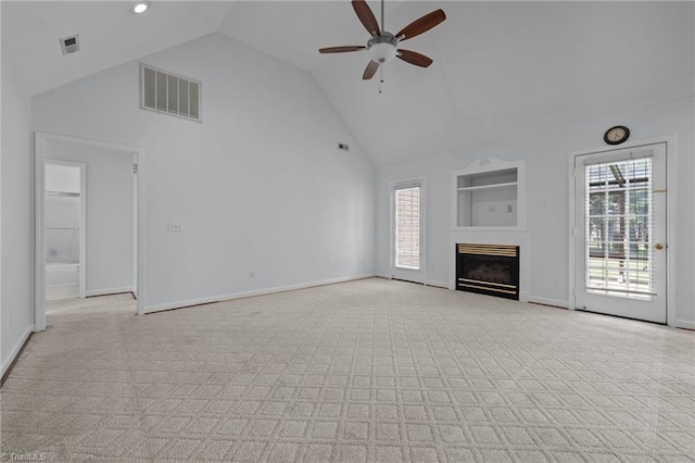 unfurnished living room with high vaulted ceiling, ceiling fan, light colored carpet, and visible vents