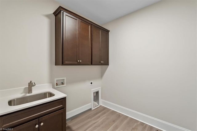 laundry area with electric dryer hookup, a sink, cabinet space, baseboards, and hookup for a washing machine