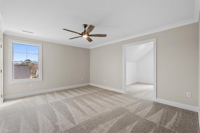 empty room with visible vents, crown molding, baseboards, and carpet floors