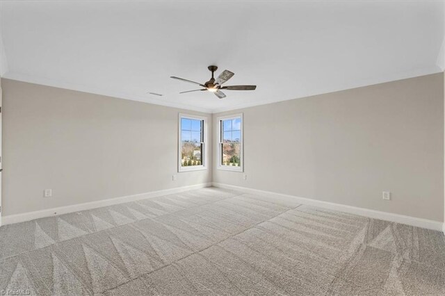 unfurnished room with baseboards, carpet floors, and crown molding