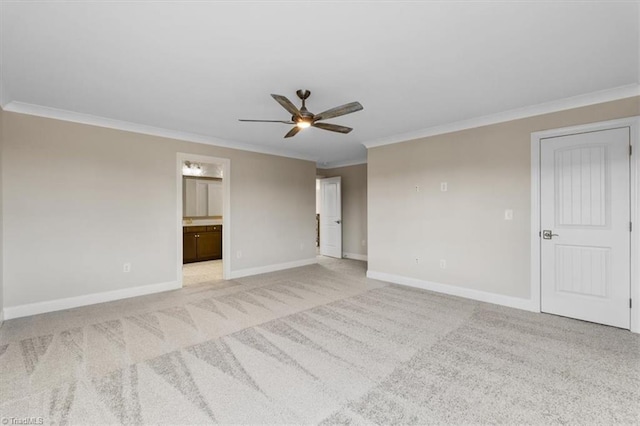 spare room with ornamental molding, a ceiling fan, baseboards, and carpet floors