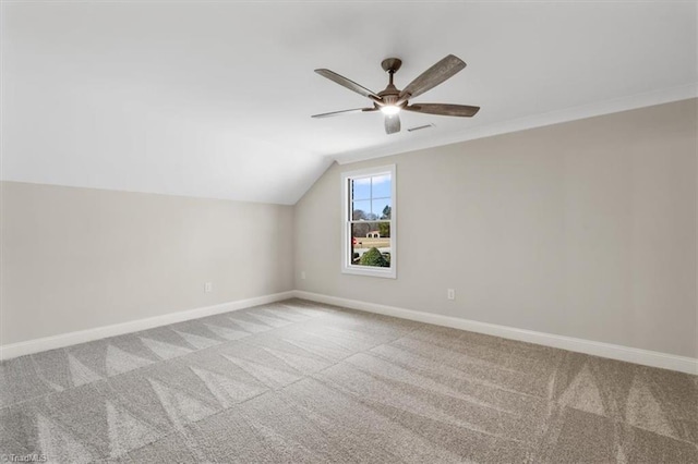 additional living space featuring visible vents, baseboards, ceiling fan, vaulted ceiling, and carpet flooring