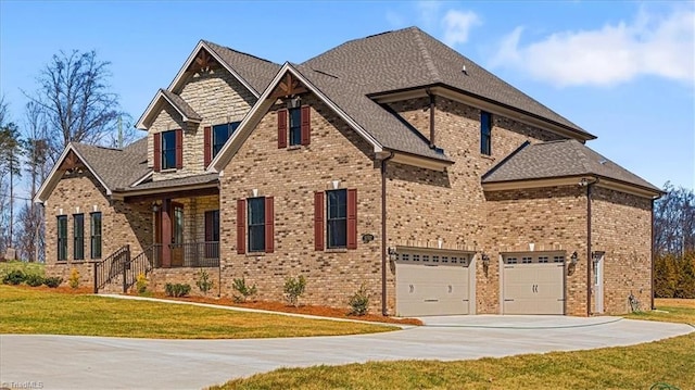 craftsman inspired home featuring brick siding, an attached garage, concrete driveway, and a front yard