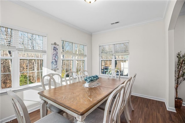 dining area featuring dark hardwood / wood-style flooring and ornamental molding