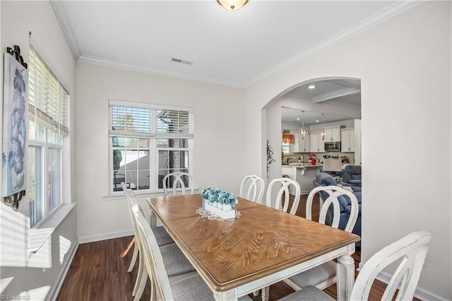 dining space with dark wood-type flooring and ornamental molding