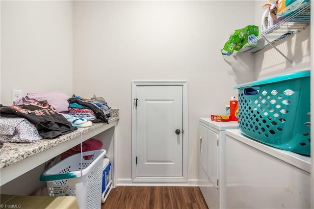 clothes washing area featuring washer and clothes dryer and dark wood-type flooring