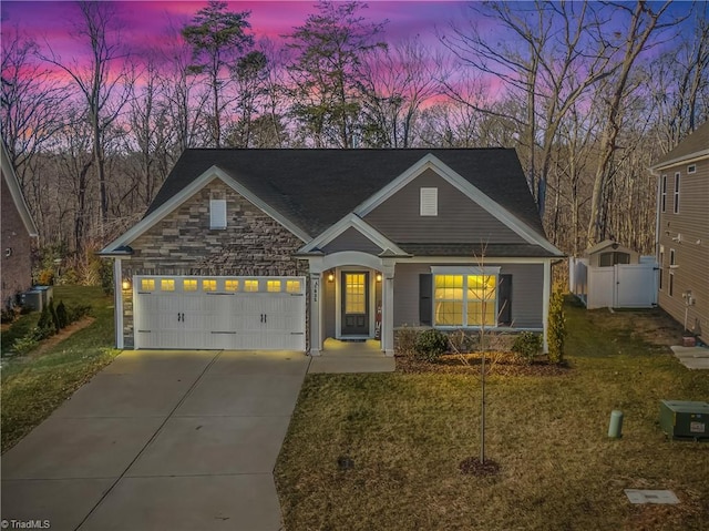 view of front of home with a garage and a yard