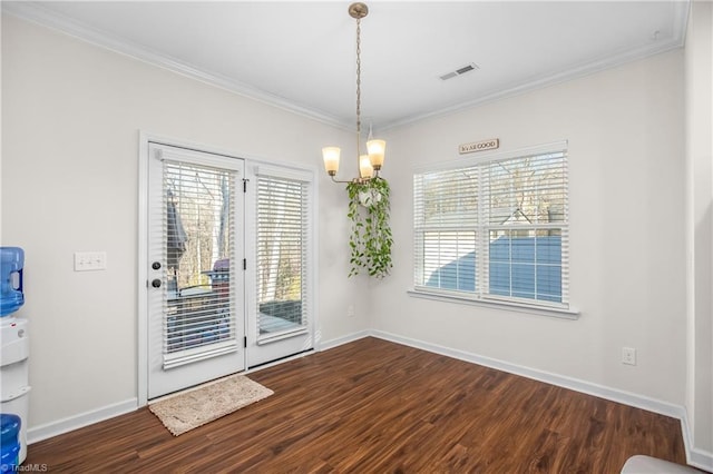 unfurnished dining area with ornamental molding, wood-type flooring, and an inviting chandelier