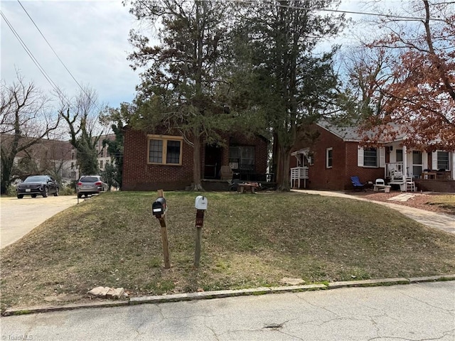 ranch-style house featuring brick siding and a front lawn