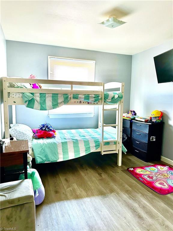 bedroom featuring wood finished floors