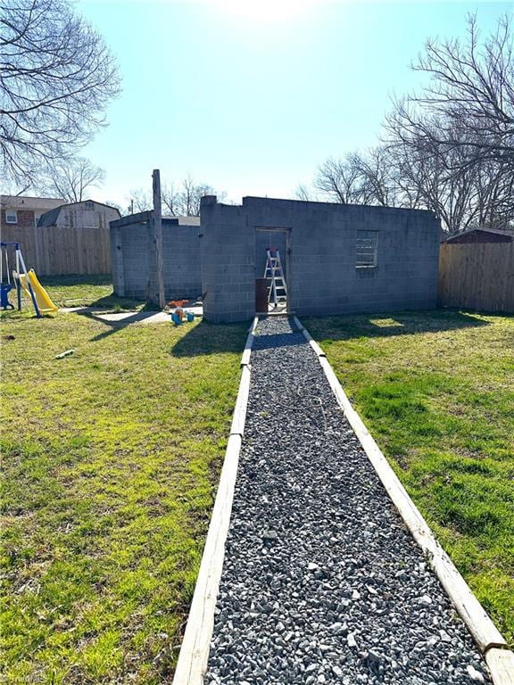 view of yard featuring a playground and fence