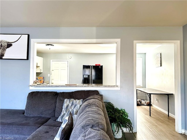 interior space featuring baseboards and wood finished floors