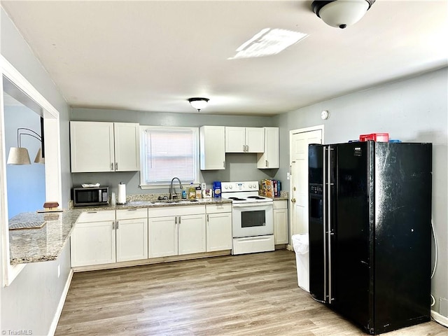 kitchen featuring a sink, stainless steel microwave, white cabinetry, white electric stove, and black refrigerator with ice dispenser