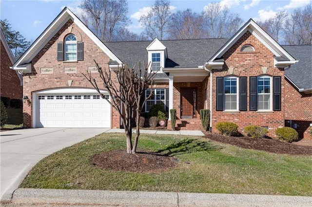 traditional-style home featuring brick siding, a front yard, driveway, and a garage