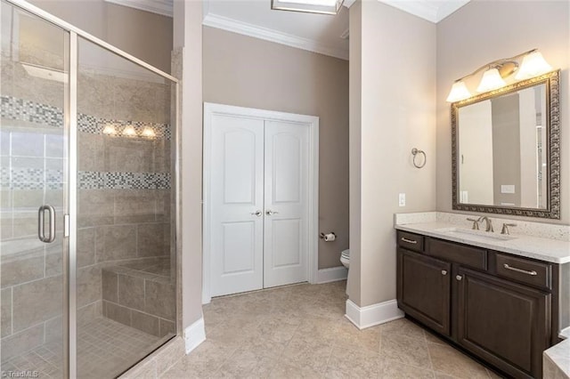 bathroom featuring vanity, ornamental molding, a stall shower, baseboards, and toilet