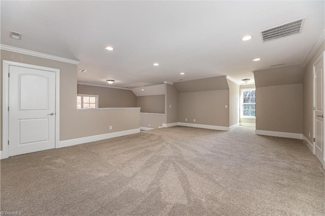 spare room with light colored carpet, ornamental molding, and visible vents