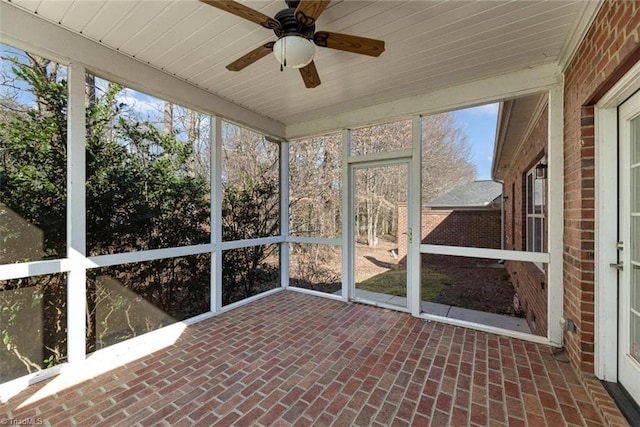 unfurnished sunroom featuring ceiling fan and wood ceiling