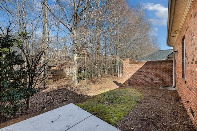 view of yard featuring fence and a patio