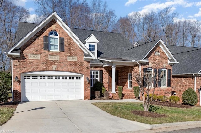 traditional-style house with brick siding, a shingled roof, and concrete driveway