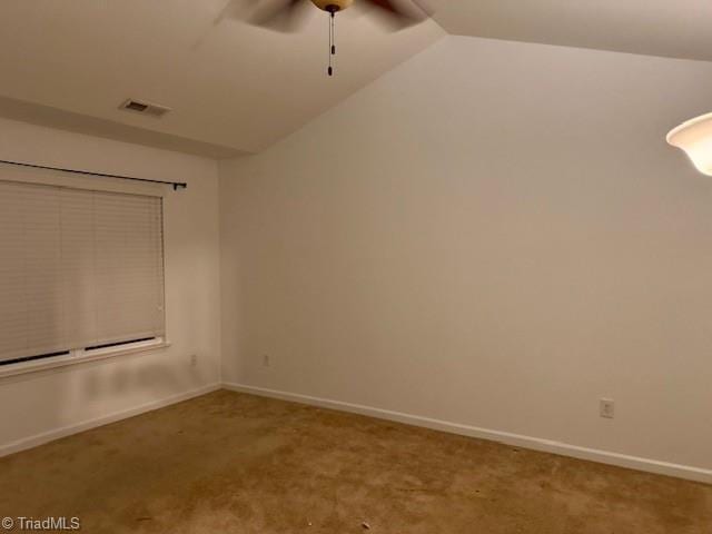 empty room featuring ceiling fan, carpet, and vaulted ceiling