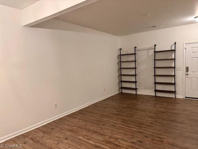 basement featuring dark hardwood / wood-style flooring