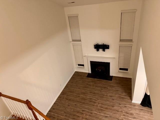 unfurnished living room with dark hardwood / wood-style floors