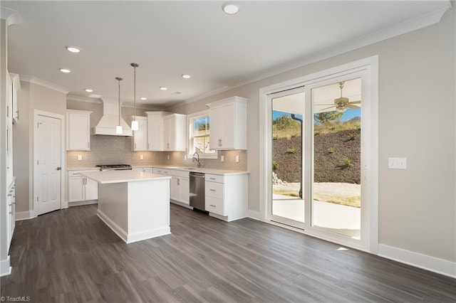 kitchen featuring a kitchen island, white cabinets, hanging light fixtures, custom range hood, and dark hardwood / wood-style floors