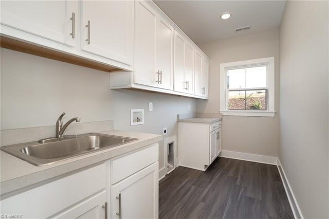 laundry area with dark hardwood / wood-style floors, cabinets, hookup for an electric dryer, sink, and hookup for a washing machine