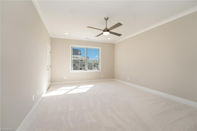 carpeted spare room featuring ceiling fan and ornamental molding