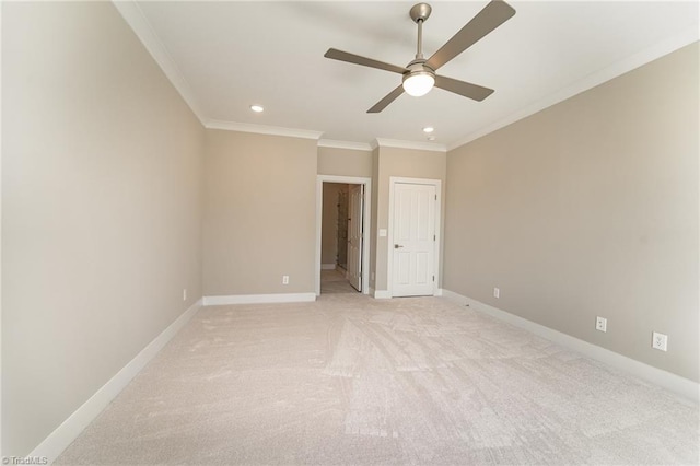 carpeted spare room featuring ornamental molding and ceiling fan