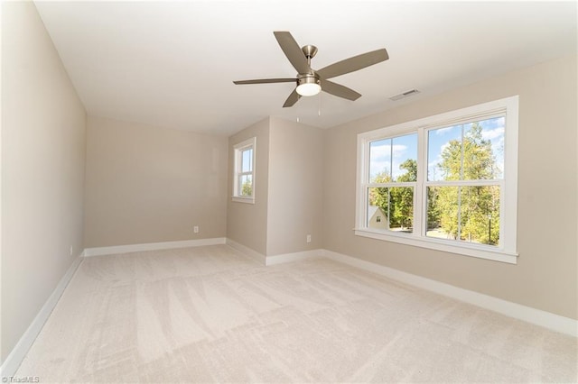 unfurnished room with light carpet and ceiling fan