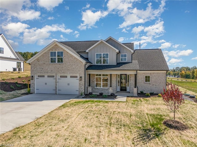 craftsman house with a front lawn and a garage