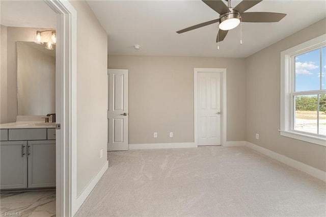 unfurnished bedroom with light carpet and ceiling fan