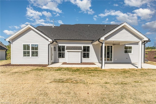 rear view of house with a patio and a yard