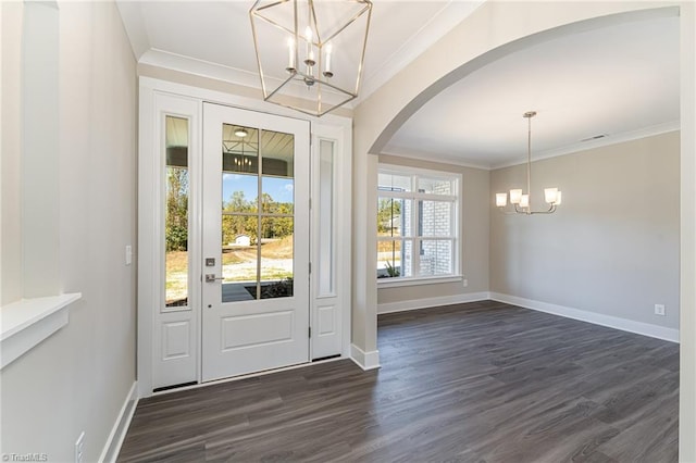 entryway featuring an inviting chandelier, crown molding, and dark hardwood / wood-style floors