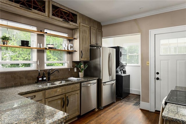 609 W Lexington Ave, High Point, NC 27262 - kitchen featuring appliances with stainless steel finishes, stacked washer / dryer, open shelves, backsplash, and dark stone counters