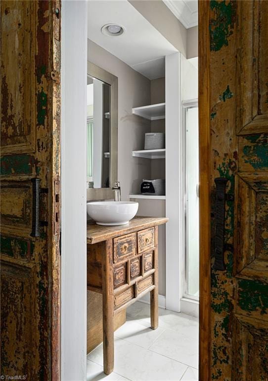 609 W Lexington Ave, High Point, NC 27262 - bathroom with vanity, tile patterned floors, and ornamental molding